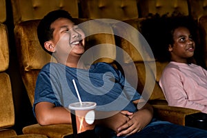 Two children having fun and enjoy watching movie