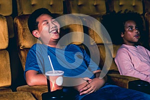 Two children having fun and enjoy watching movie