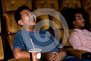 Two children having fun and enjoy watching movie