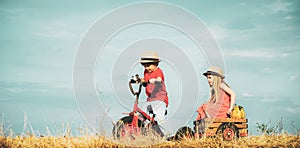 Two Children having fun in field against blue sky background. Happy children farmers working with spud on spring field