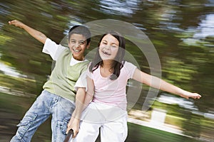 Two children having fun on roundabout