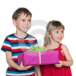 Two children hold a gift box