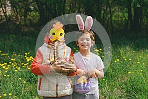 Two children hunt for Easter eggs in a spring garden. Easter tradition