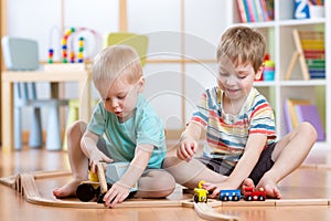 Two children little boys playing role game in daycare photo
