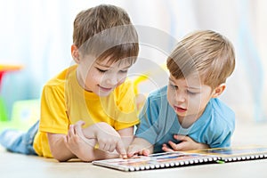 Two children looking at book