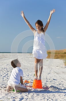 Two Children Making Sandcastles on Beach