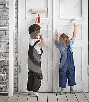 Two children paint indoors