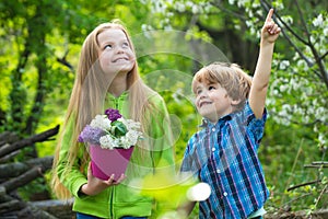 Two children planting vegetable in garden. American farm life. Eco resort activities. Summer leisure. Happy kid on