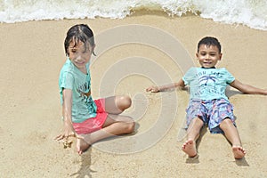 Two children playing on the beach in thailand
