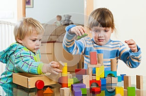 Two children playing with blocks