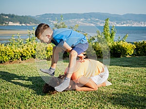 Two children playing leap frog outdoors