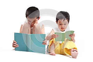 Two children reading book