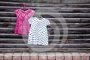 Two children`s dresses for girls on hangers