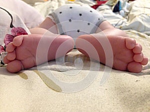 Two children`s heels in different directions, the first photos newborn. infant heel feet.