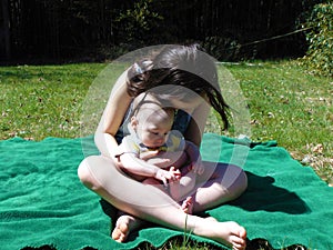 Two Children Sitting Outdoors In Spring