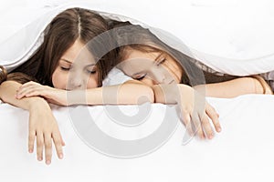 Two children sleeping in bed