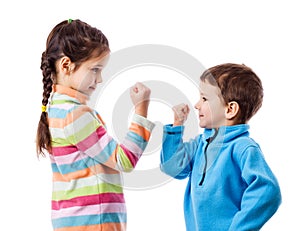 Two children threaten each other a fist