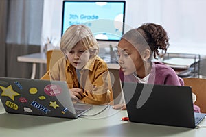 Two Children Using Laptop Computers in Class