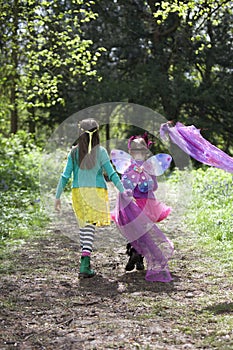 Two children walking along a woodland path