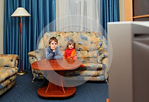 Two children watch tv