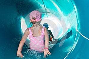Two children on water slide at aquapark