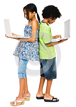 Two children working on laptops