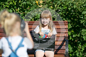 Little girls record a video blog on the camera photo