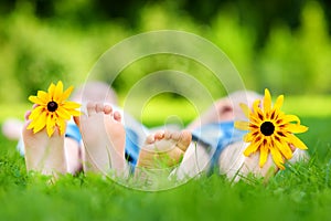 Two childrens feet on grass outdoors