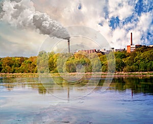 Two chimneys and buildings at the river coast