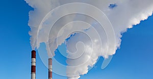 Two chimneys pipes with thick white smoke. Air pollution, environmental problems, air emissions
