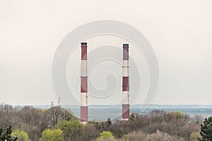Two chimneys on sky background. Industry air pollution concept