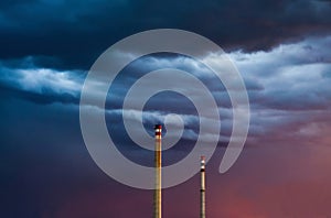 Two chimneys on stormy sky