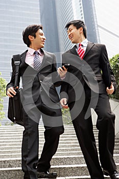 Two Chinese Businessmen Having Discussion