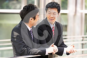 Two Chinese Businessmen Outside Modern Office