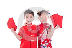 Two chinese children in traditional costume holding red packet money over white