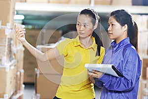 Two chinese female workers in warehouse photo