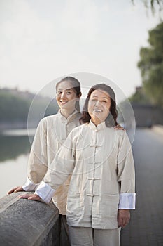 Two Chinese Women With Tai Ji Clothes Smiling At Camera