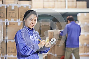 Two chinese workers in warehouse