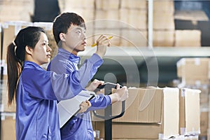 Two chinese workers in warehouse photo