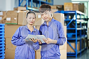 Two chinese workers in warehouse photo