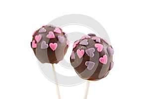 Two chocolate cakepops with hearts decoration