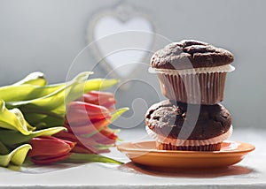 Two chocolate chip muffins and tulips