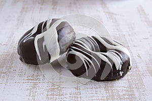 Two chocolate covered donuts