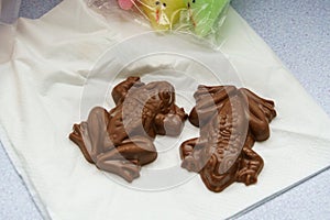 Two chocolate frogs on a napkin