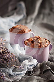 Two chocolate muffins in lilac cups