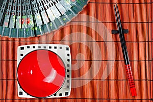 Two chopsticks on sushi mat background