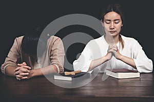 Two Christians praying worship believe, praying and praise together at home, devotional or prayer meeting concept photo