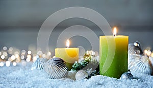 Two Christmas candles on snow