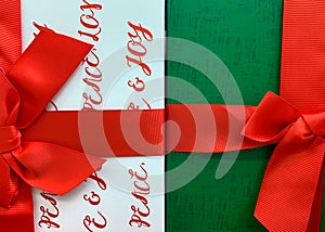 Two Christmas gift boxes with red ribbons and bows