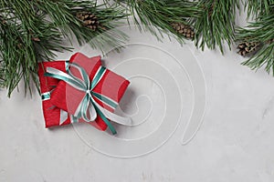 Two Christmas gifts in red paper with green and white ribbons on gray background. Xmas holiday presents. Flat lay. Boxing day.